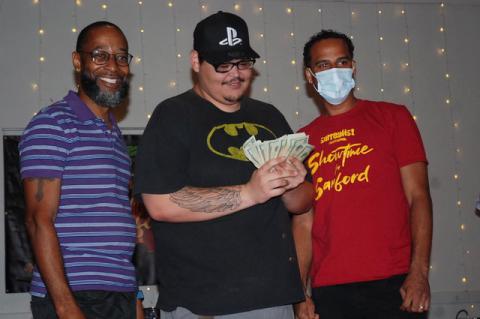 Priceless Hero poses for photos with his winnings and host Jay Love, left, and show organizer Lawrence Gordon, right.