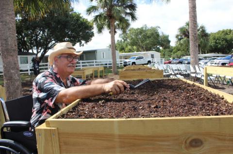 Community Garden President Raymond Simmons tests out how the disability-friendly garden will work for those in wheelchairs.