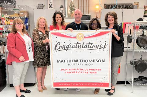 2024 High School Teacher of the Year Matthew Thompson (above) with members of the school board.