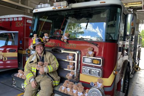 Seminole County Fire Department Firefighter Chris O’Neill with the donated ‘Trauma Teddy Bears’ from Rotary Club of Lake Mary.