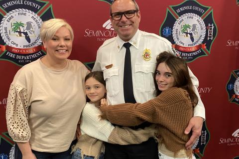 Deputy Chief of Administration John Thibert with his family at the ceremony. 