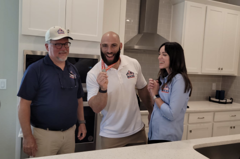 Air Force Staff Sgt. Matthew Cable (center) shows of the keys to his new home in DeBary.
