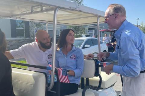 Air Force Staff Sgt. Matthew Cable (left) with wife Ensley and Building Homes for Heroes Founder and CEO Andy Pujol during the home reveal in DeBary on Tuesday. 