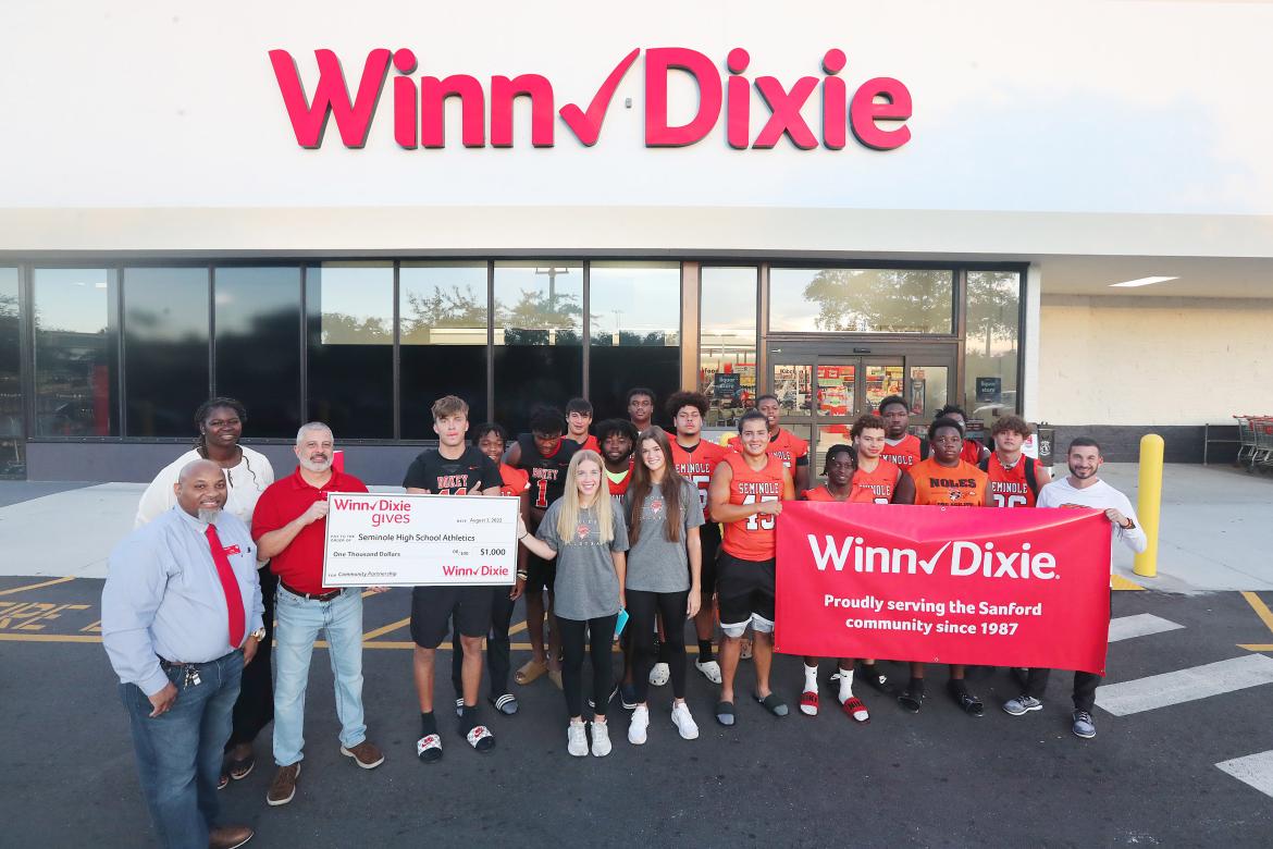 Members of the Seminole High School Athletics teams accept a $1,000 check from Winn-Dixie. 