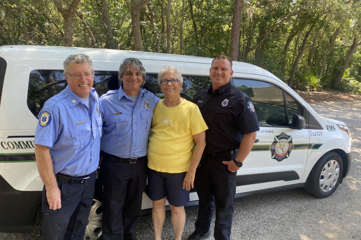 Paramedics with resident Marilyn Logan of Winter Springs (yellow shirt), who is a caregiver served by the Community Paramedicine Program.
